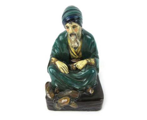 A Royal Doulton figure 'The Cobbler' in green and blue robes. HN 542. H. 21 cm CONDITION REPORT: Some crazing and loss of pai