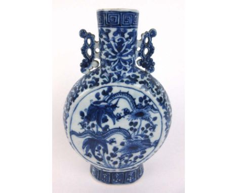 A 19th century Chinese blue and white moon flask with each side depicting dragons amidst foliage. H. 27 cm CONDITION REPORT: 