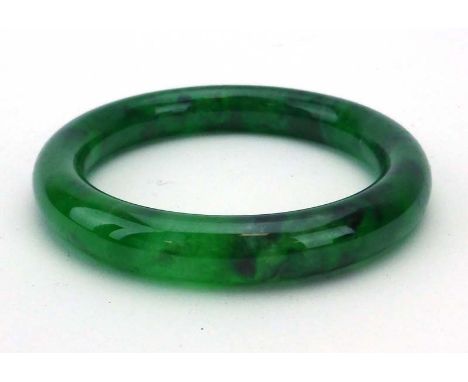 A green jade bangle, internal d. 5.9 cm