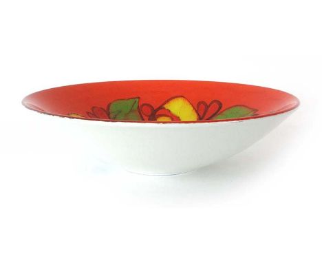 A Poole pottery fruit bowl decorated in the 'Delphis' pattern with a green and yellow flower on a red ground, shape 58, d. 35