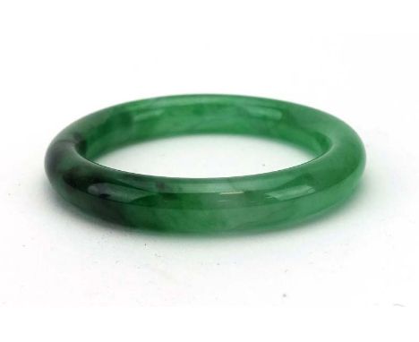 A green jade bangle, internal d. 5.9 cm