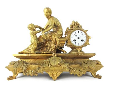 A large late 19th century French gilt mantle clock, the case modelled as a classical lady and child with foliate decoration a