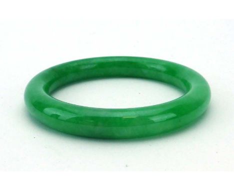 A green jade bangle, internal d. 5.7 cm