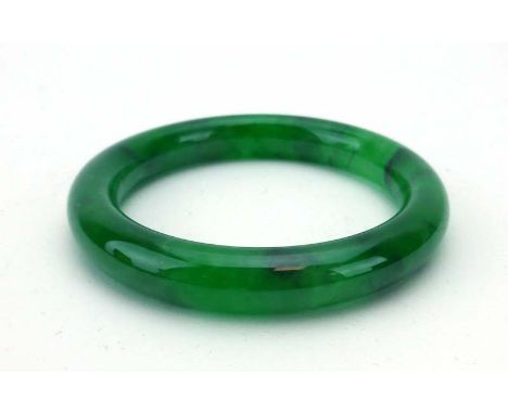 A green jade bangle, internal d. 5.9 cm