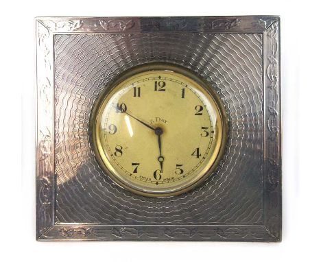 A silver framed travelling clock with engine turned decoration and an 8 day movement. Hallmarked for Birmingham, 1925. H. 9 c