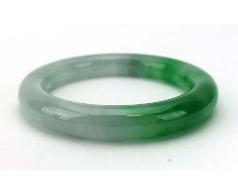 A green jade bangle, internal d. 5.6 cm