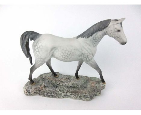 A large Beswick ceramic figure of a horse in mottled grey colours on naturalistic base. H. 29 cm. CONDITION REPORT: No obviou