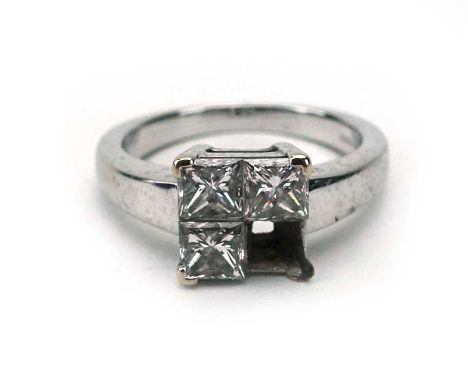 An 18ct white gold ring set three princess cut diamonds in a square shaped setting, ring size K, 4.5 gms (af) CONDITION REPOR