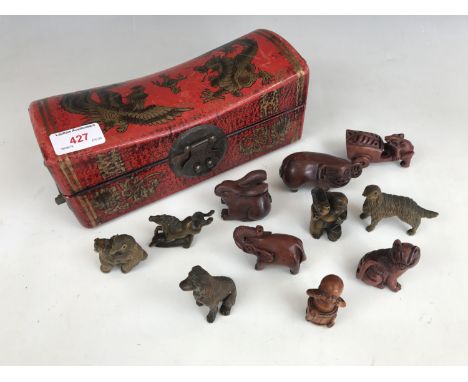 A quantity of reproduction netsuke together with an oriental lacquered casket