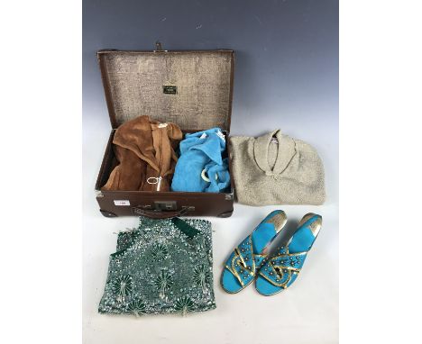 A vintage travel case containing two 1960s velour playsuits, a sequinned shift top, a gold lame top and a pair of 1960s conti