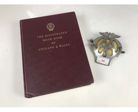 A vintage AA bumper badge and Road Book