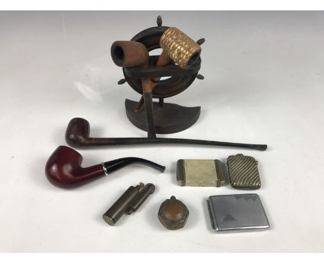 Vintage smoking paraphernalia including a nautical pipe rack modelled as a ships wheel, pipes, vesta cases, and brass lighter