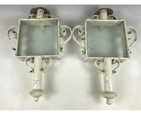 Two wrought-iron and glass exterior light sconces