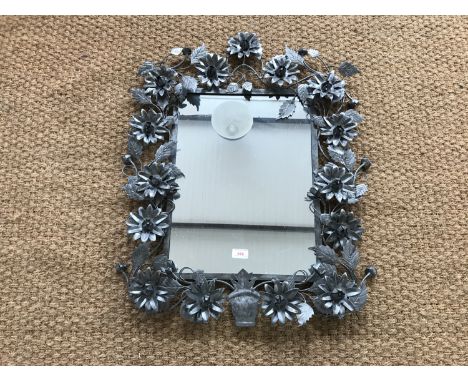 An elaborate wrought metal wall mirror