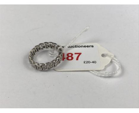 A vintage paste-set eternity ring, divided into millegrain cells connected by spacers