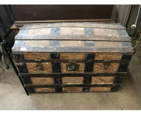 A late 19th Century domed-top trunk with metal straps