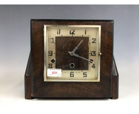 An Art Deco mahogany cased mantel clock, having a Norland movement with Westminster chime