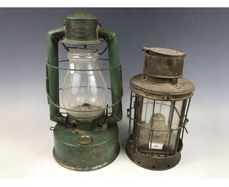 A vintage Gael Brooder paraffin lamp together with one other