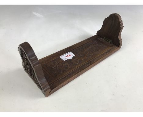 A vintage chip-carved mahogany bookslide, 44 cm extended