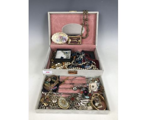 A costume jewellery box containing a large quantity of vintage costume jewellery, including necklaces, brooches, bangles and 