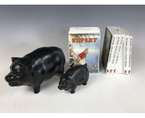 A pair of Wedgwood porcelain "Rupert the Bear" children's book money boxes / bookends, together with a Sylvac piggy bank and 