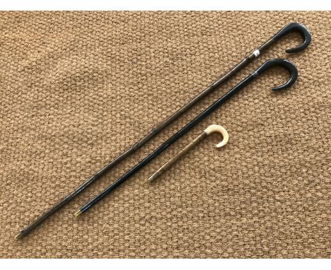 A shepherd's crook together with a stick and miniature stick