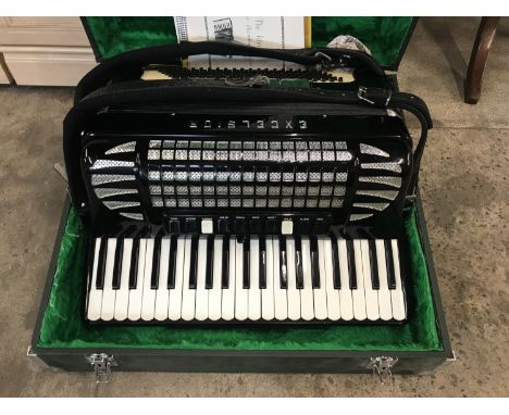 A cased Excelsior piano accordion with related ephemera