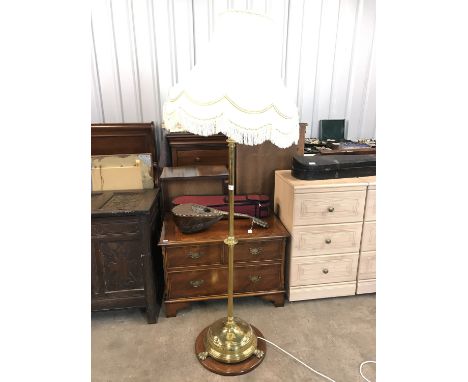 A Victorian brass standard lamp with cream shade