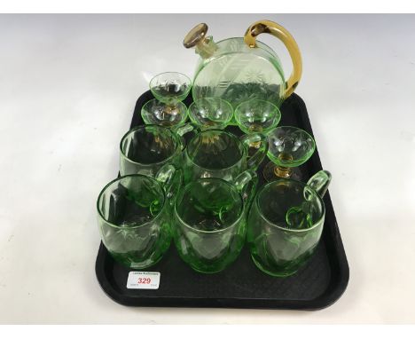 An emerald green decanter with glasses, together with five further emerald green glass cups