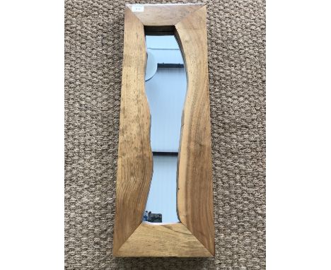 A contemporary light oak framed wall mirror