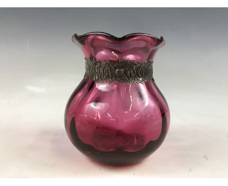 An antique silver-mounted cranberry glass vase