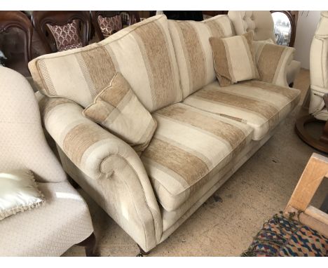 A contemporary two-seater beige and mocha upholstered sofa