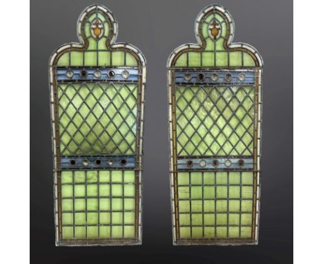 A pair of lancet windows, pale blue and green-stained glass, with central clear and amber glass roundels, within two borders 