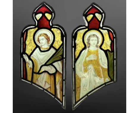 A pair of Angels holding palm branches, symbolising martyrdom, two trapezoidal stained, painted and leaded glass windows with