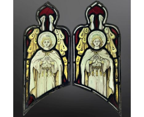 Angels at Prayer, a pair of trapezoidal stained, painted and leaded glass windows with ogee pediments, each 56cm by 23cm. * P