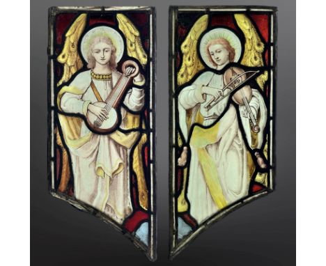 A pair of Angel Musicians, a lutenist and a violinist, two trapezoidal stained, painted and leaded glass windows with ogee pe