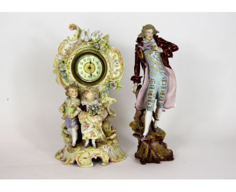 A Continental porcelain figural mantle clock, florally enamelled, 26cm high and a porcelain figure of a dandy 25cm high (2)