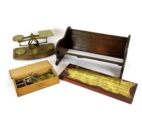 A set of brass postal scales, on bow fronted beech stand, and a part set of weights; together with a oak adjustable book trou