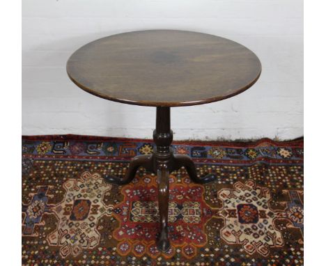 A George III mahogany tilt top circular table, with turned column on tripod base and pad feet, 74 x 70cm diam