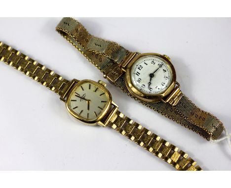 A lady's Rotary yellow metal wristwatch, with cushion shaped face, silvered dial and gold batons, unmarked, attached 9ct gold