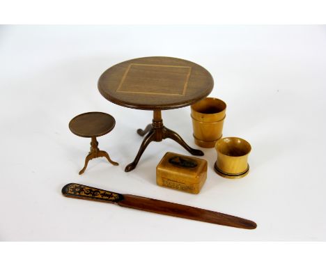 An apprentice tilt top tripod table, a yew wood miniature table signed 'B Dickinson', a Tunbridgeware page turner and three p