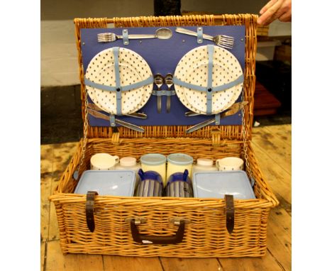 A Brexton picnic hamper with blue and white accessories