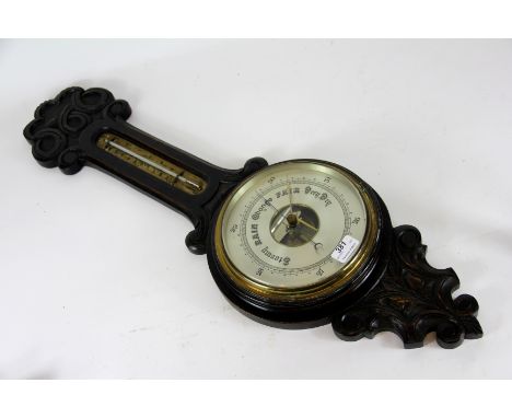 A late Victorian carved oak aneroid barometer, with silvered dial, 83cm  