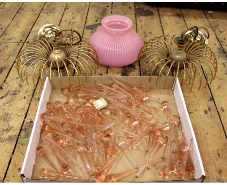 Two ceiling lights hung with pink glass drops and a pink glass lamp shade and other lighting