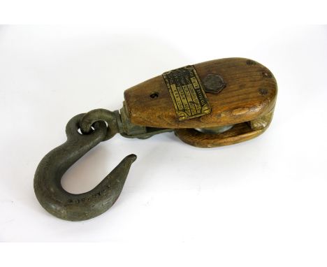 An early 20th military issue snatch block, with brass patent plate stating that it is to reeve 2 1/2 rope, the hook stamped T