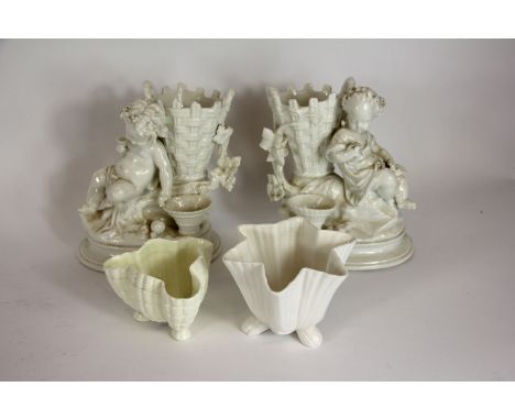 A pair of continental figural spill vase groups, each modelled with a bacchante beside a basket; a Royal Worcester shell dish