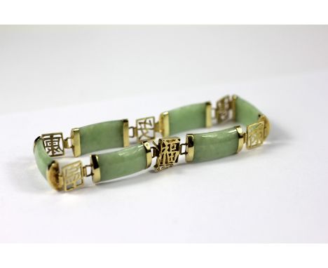 A Chinese 14ct gold and jade set bracelet, the six jade panels interspersed with six gold characters, the integral clasp stam