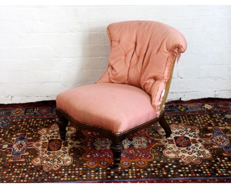 A Victorian walnut button back nursing chair on turned and fluted legs, 66cm high (at fault) 