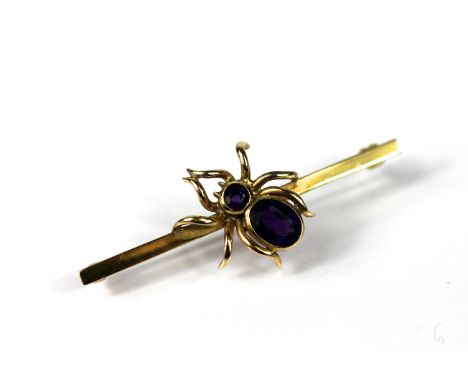 A 9ct gold and amethyst Cropp and Farr brooch, London 1987, designed as a central bar set with an amethyst set spider, bar 5c