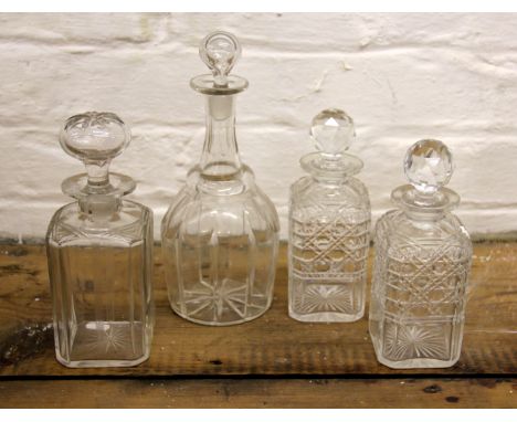 A 19th century mallet shaped decanter and stopper, along with a square section decanter and stopper with star cut base and tw